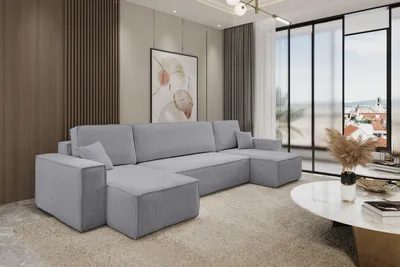 A modern living room with a large sectional sofa, a coffee table, and a large window overlooking a city.