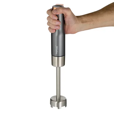 A hand holding a Hagenuk immersion blender against a white background.