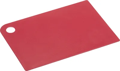 A red plastic cutting board with a hole in the corner, lying flat on a white background.