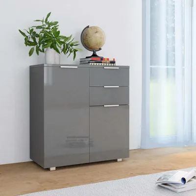 A gray sideboard with drawers and doors, decorated with a plant and a globe.
