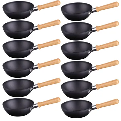 A grid of small black woks with wooden handles against a white background.