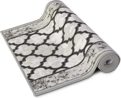 A rolled-up rug with a geometric pattern.