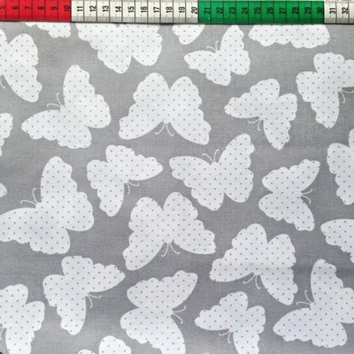 Produktbild von Baumwolle 100% Schmetterlinge weiß auf grauem Hintergrund