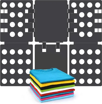 A set of black plastic folding boards for laundry, with a stack of colorful t-shirts in the foreground.