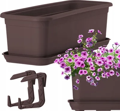 A brown plastic planter with a matching saucer and two brown plastic balcony railing brackets, with a cluster of purple petunias in a second planter in the foreground.