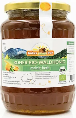 A jar of honey on a white background with a label showing a landscape and product details.