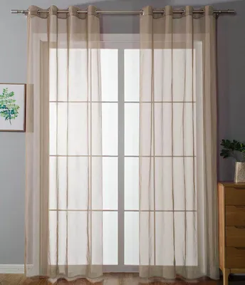 A window covered by sheer, sand-colored curtains.