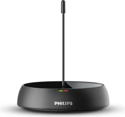 A black Philips charging dock with a thin black antenna-like protrusion in the center. There are small green and red indicator lights on the front of the dock.