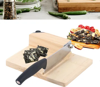 A close-up of a wooden guillotine-style slicer with a knife and some cut food items.