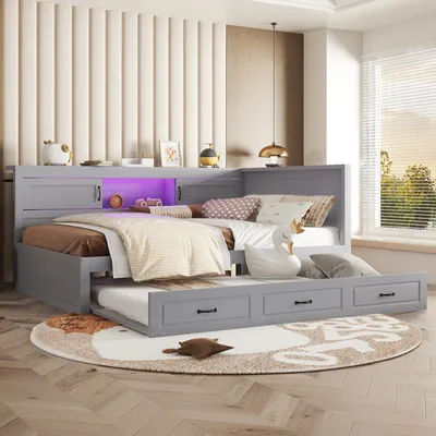 A bedroom scene featuring a grey bed with a pull-out trundle and storage drawers, illuminated by purple LED lights.
