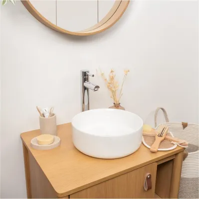 A bathroom vanity with a vessel sink and faucet.