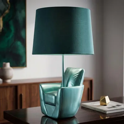 Immagine prodotto di Lampada da tavolo, design poltrona, realizzata in resina, rivestita in tessuto, dimensioni 26x43 cm, colore turchese, modello Mauro Ferretti