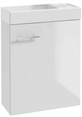 A white bathroom vanity with a sink and a chrome handle.