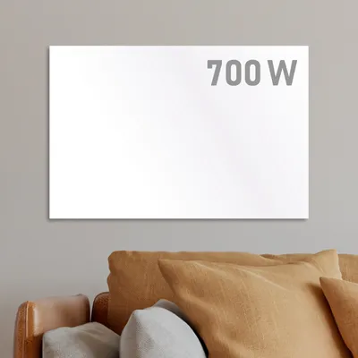 A white infrared heater mounted on a light gray wall above a sofa.
