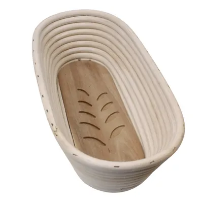 An oval-shaped bread proofing basket with a wooden base.