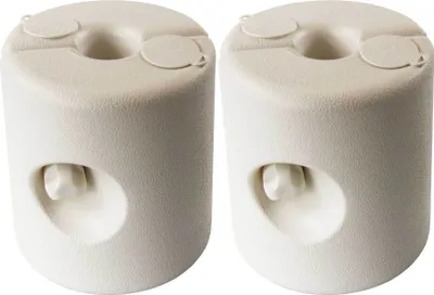 Two beige plastic tent weights are shown against a white background.