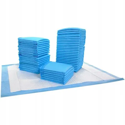 Three stacks of blue pet training pads are arranged on top of a larger, unfolded pet training pad.