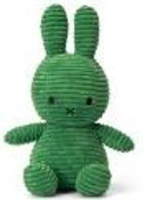 A green corduroy Miffy bunny toy sitting against a white background.