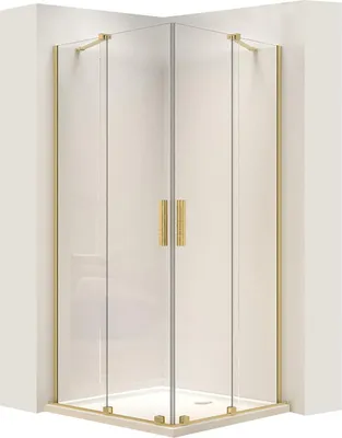 A corner shower cabin with gold-colored frames and handles.