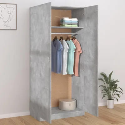 An open wardrobe with clothes hanging inside and folded clothes on a shelf, with a plant in a pot to the right.