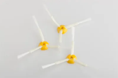 Three replacement side brushes for an iRobot Roomba vacuum cleaner are arranged on a white background.