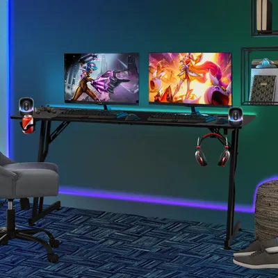 A gaming desk setup with dual monitors, a chair, and accessories in a room with ambient lighting.