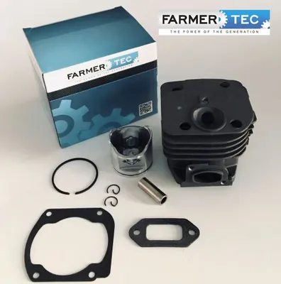 A set of engine parts, including a cylinder, piston, and gaskets, are laid out on a white surface next to a product box.