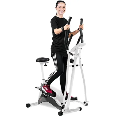 A woman is using a white and black elliptical cross trainer with a seat.