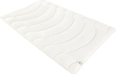A white quilted duvet on a white background.
