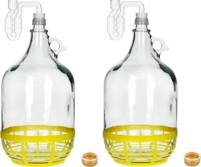 Two clear glass carboys with yellow protective bases and airlocks are displayed against a white background. Two small corks are also visible at the bottom.