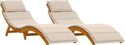 Two wooden sun loungers with cream cushions are shown against a white background.