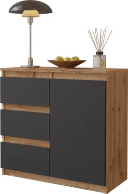 A modern sideboard with drawers and a door, decorated with a lamp, a bowl of apples, and a diffuser.