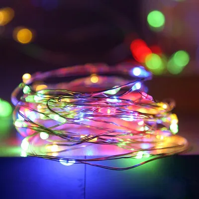 A close-up shot of a coiled string of multi-colored LED lights.