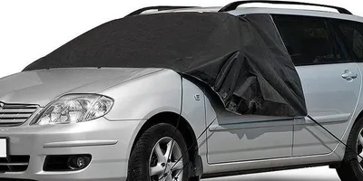 A silver car with a black frost cover on the windshield and hood.
