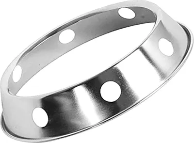 A silver wok ring with circular holes.