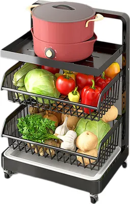 A three-tiered rolling kitchen cart filled with various fresh vegetables and a pot on the top shelf.