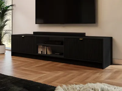 A black TV lowboard with two doors and a shelf is shown in a living room setting, with a TV and soundbar mounted above it.