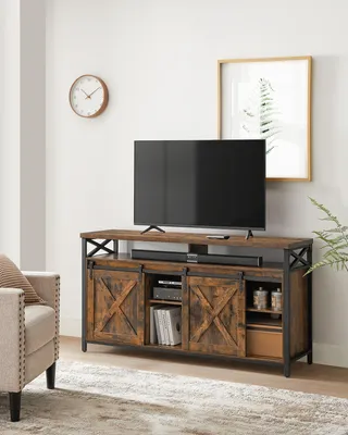 A living room scene featuring a TV stand with a television and soundbar.