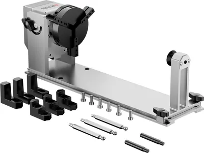 A product shot of a rotary roller attachment for a laser engraver, with various accessories laid out.