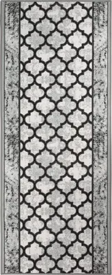 A runner rug with a geometric pattern.