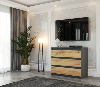 A modern living room with a TV mounted on the wall above a dresser and a floor lamp.
