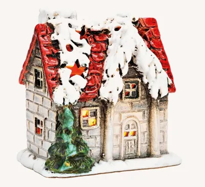 Dekoratives, kleines Haus, das an ein Weihnachtsdorf erinnert. Das Haus hat ein rotes Ziegeldach.
