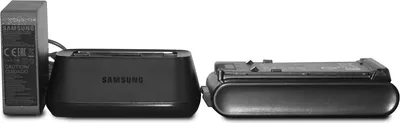 A black Samsung battery charger and a battery are displayed against a white background.