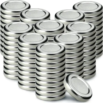 A collection of metal jar lids stacked in columns.