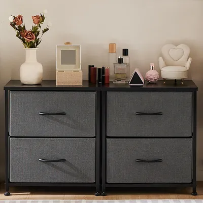 A dresser with two drawers on each side, decorated with various cosmetic items and a vase of flowers.