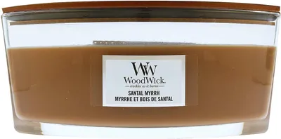A close-up view of a WoodWick candle in a glass jar with a wooden lid.