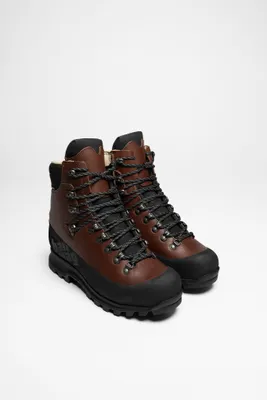 A pair of brown and black trekking boots are displayed against a white background.