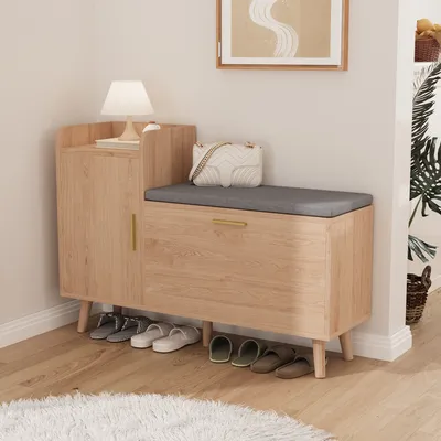 A shoe cabinet with a bench seat in a hallway or entryway.