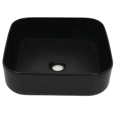 A black square washbasin with a drain hole in the center.