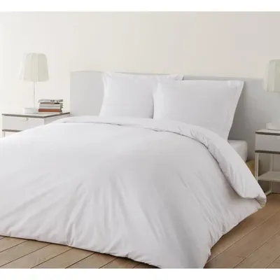 A neatly made bed with white bedding and pillows.